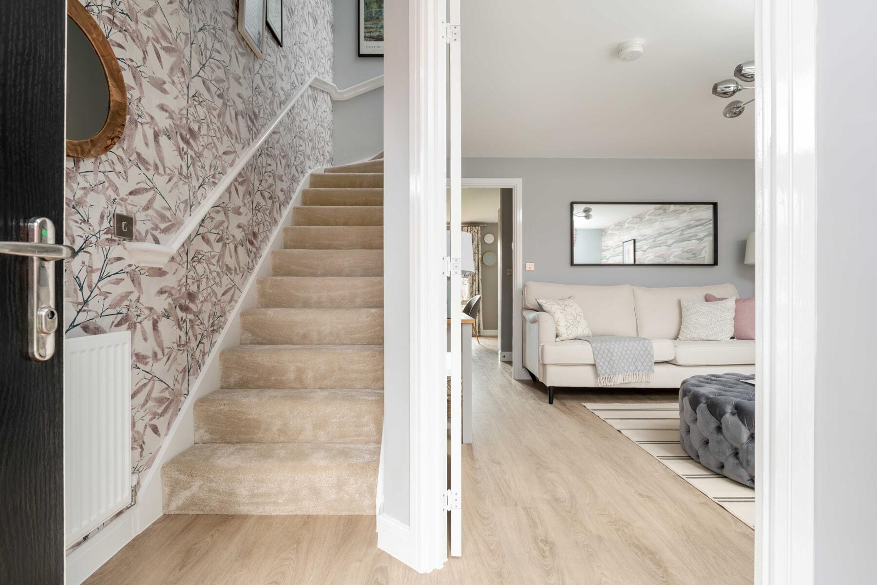 Hallway with stairs and view into living room 