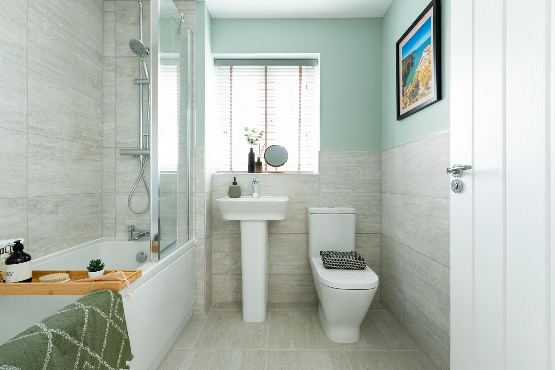 Shower over the bath with sink and toilet 