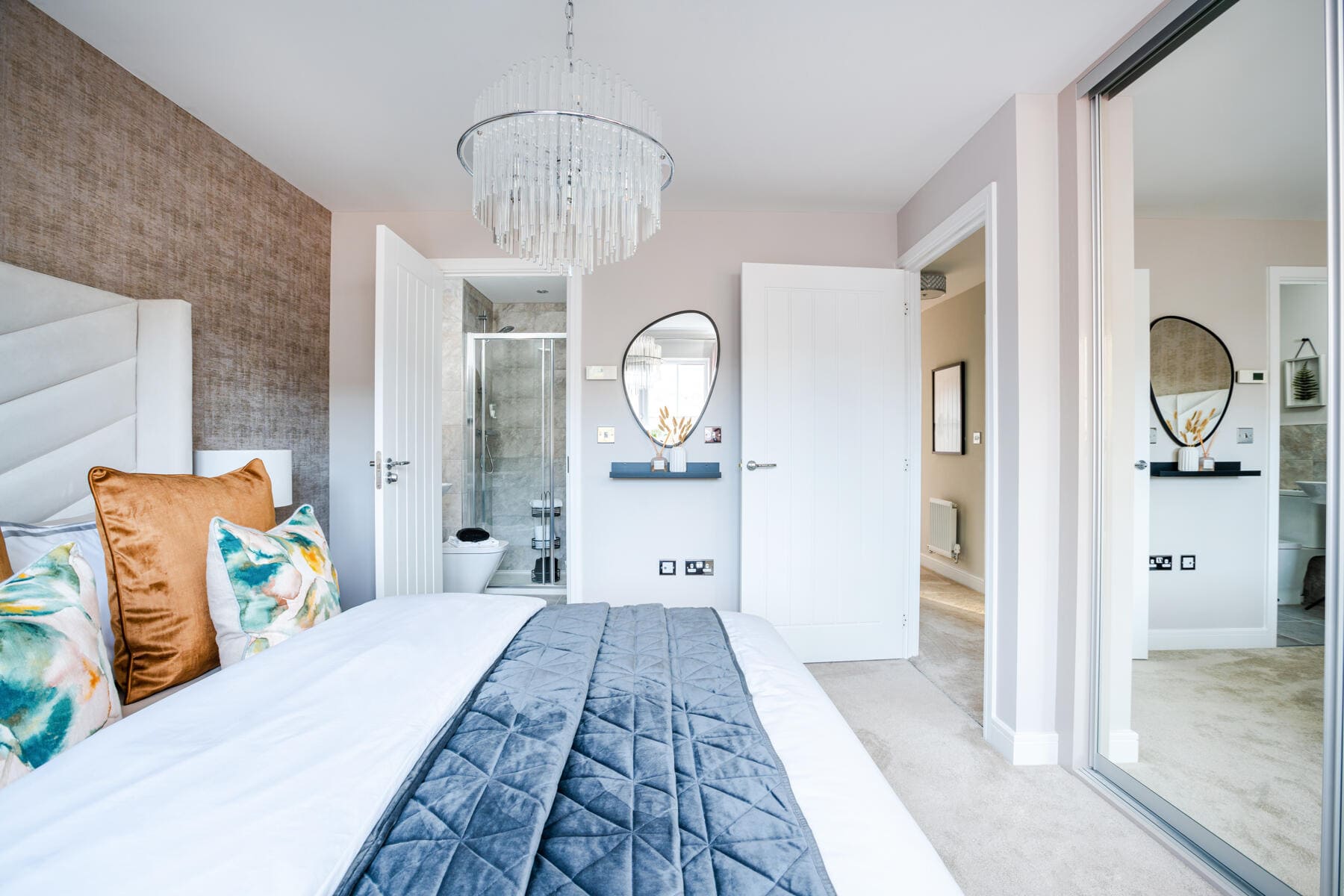 Bed with view to the en suite and wardrobe 