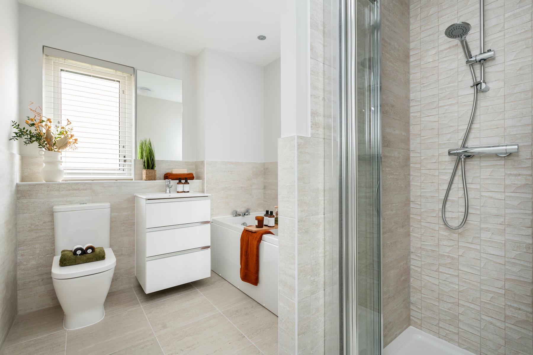 Toilet, sink and shower in bathroom