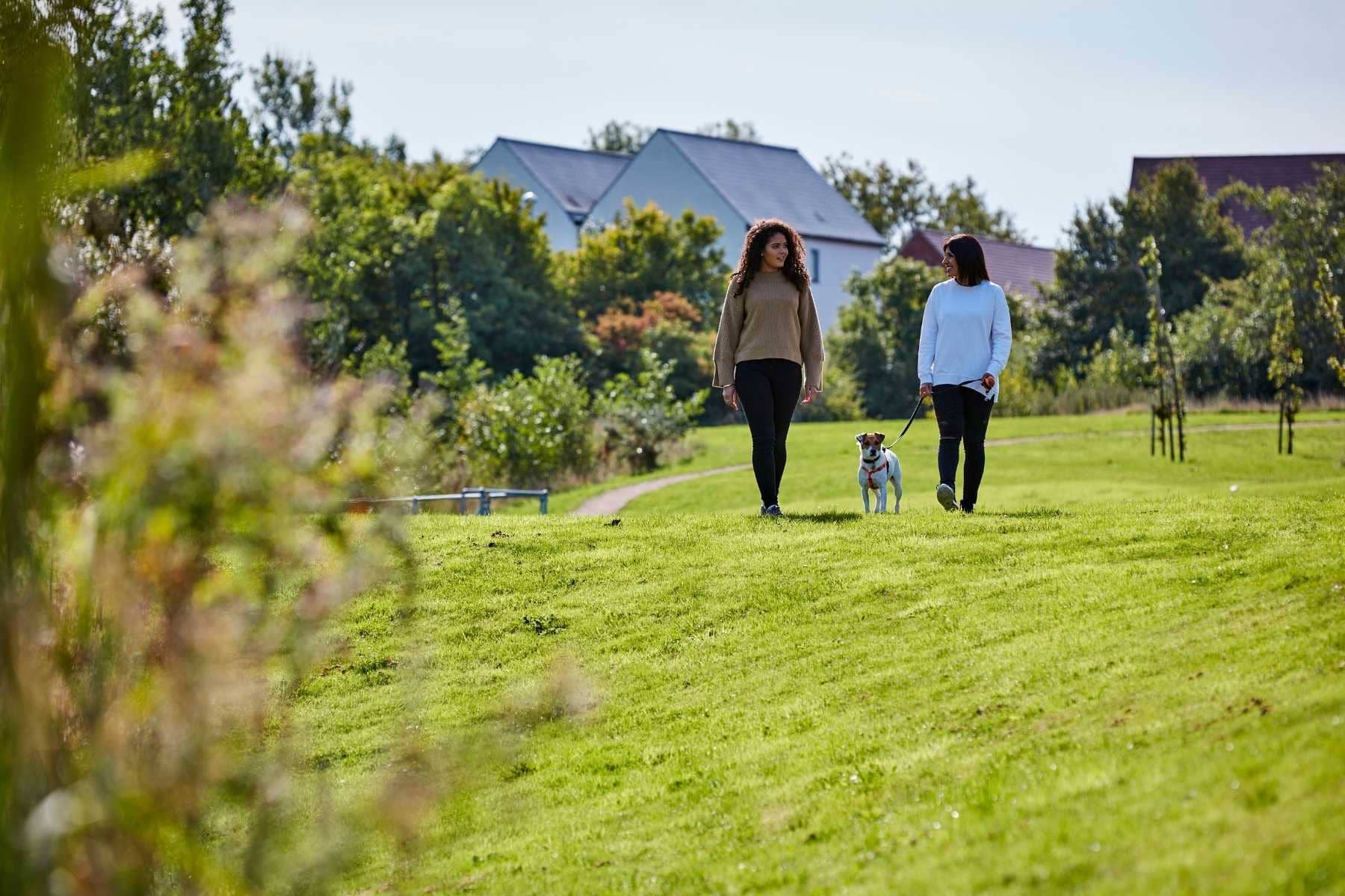 mum and daughter walking a dog