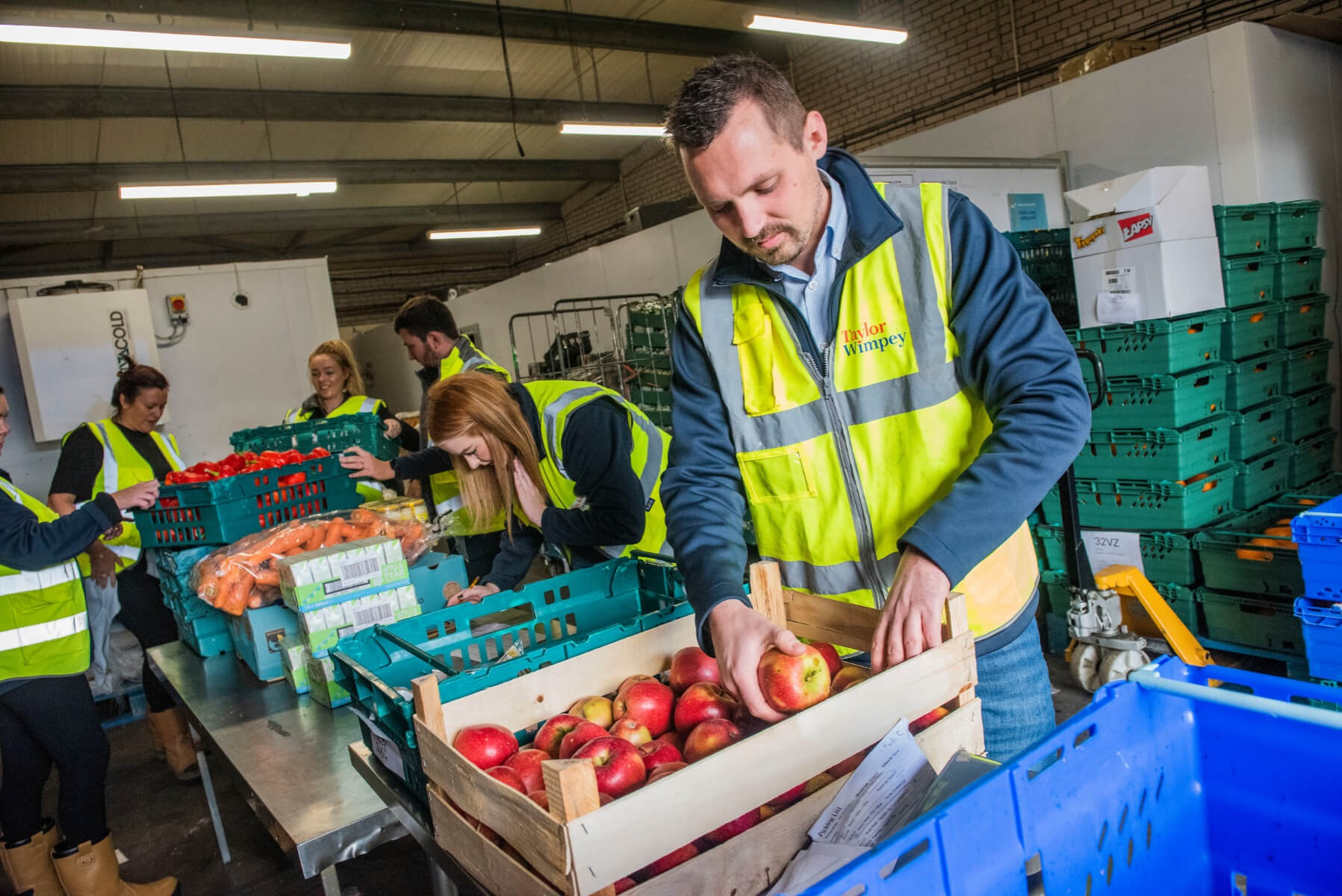 Taylor Wimpey staff giving a helping hand at the food bank warehouse