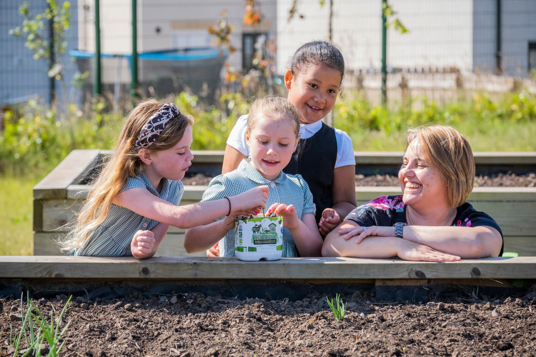 Karen Malt, Taylor Wimpey East Scotland’s local sustainability champion with Melissa Shaw, Buglife Conservation Officer and children from Letham Mains Primary School