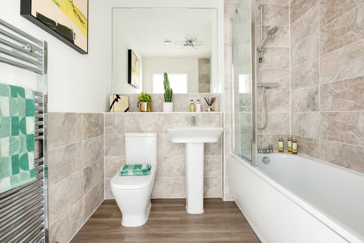 Bathroom featuring tiling & heated towel rail