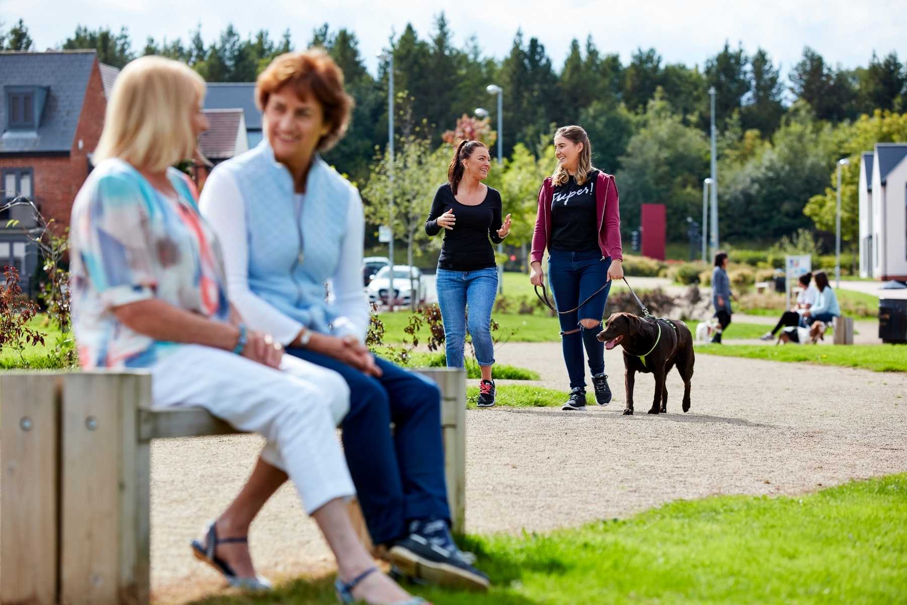 ladies sat on bench in a community park