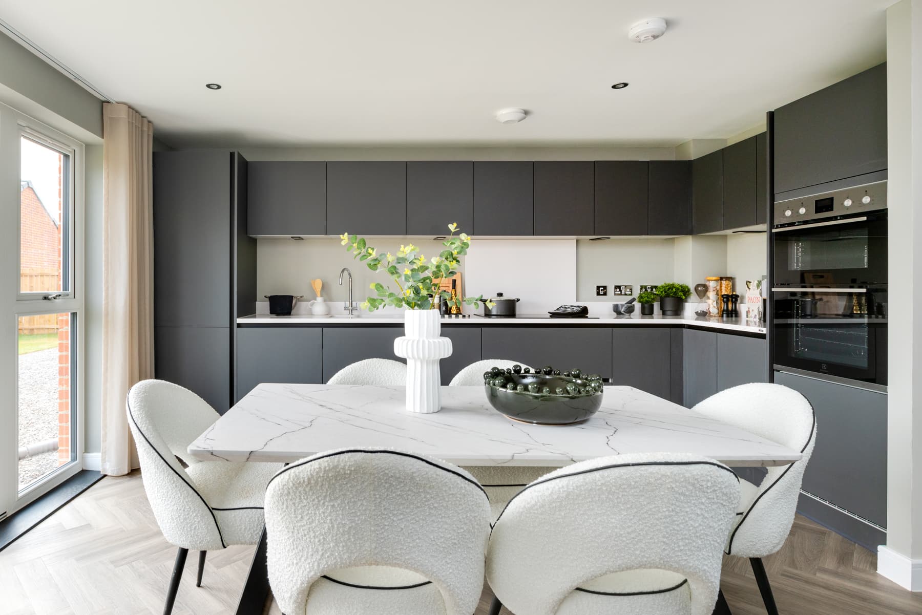 A modern kitchen and dining area with ample storage