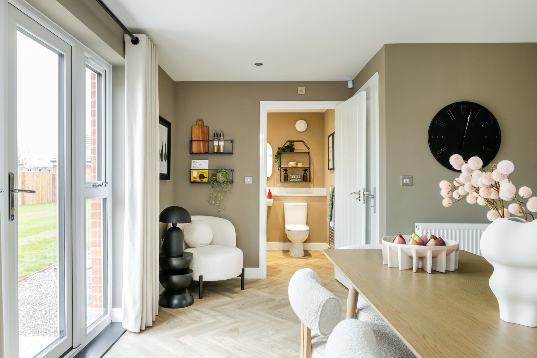 The kitchen leads to the cloakroom