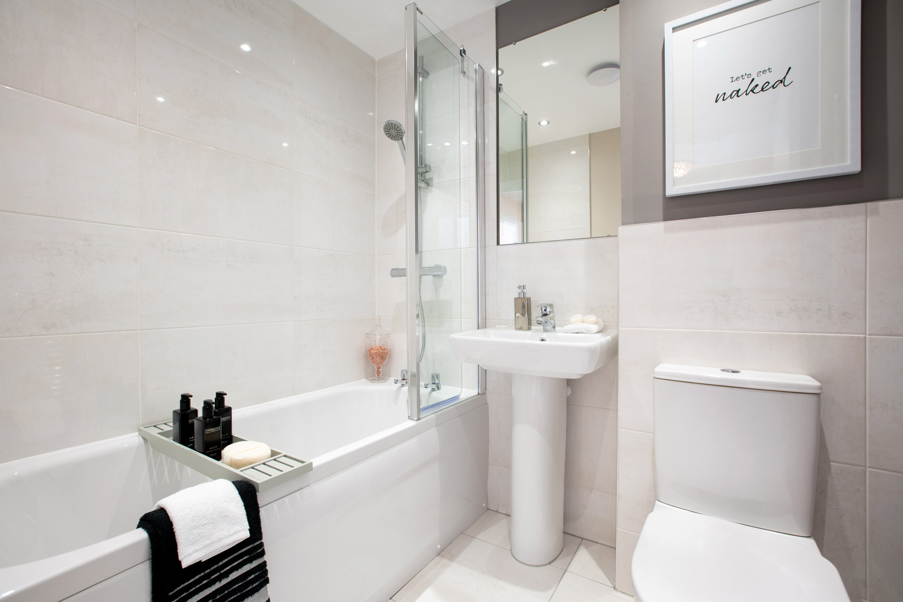 A stylish bathroom with shower over the bath