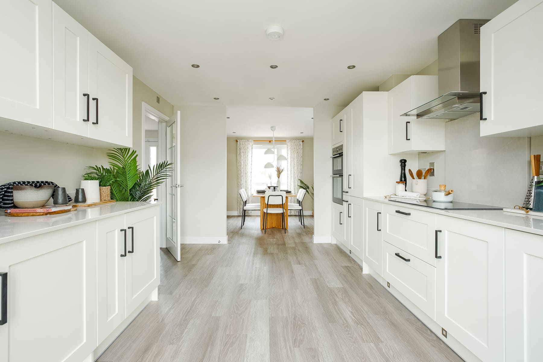 Galley kitchen through to dining area