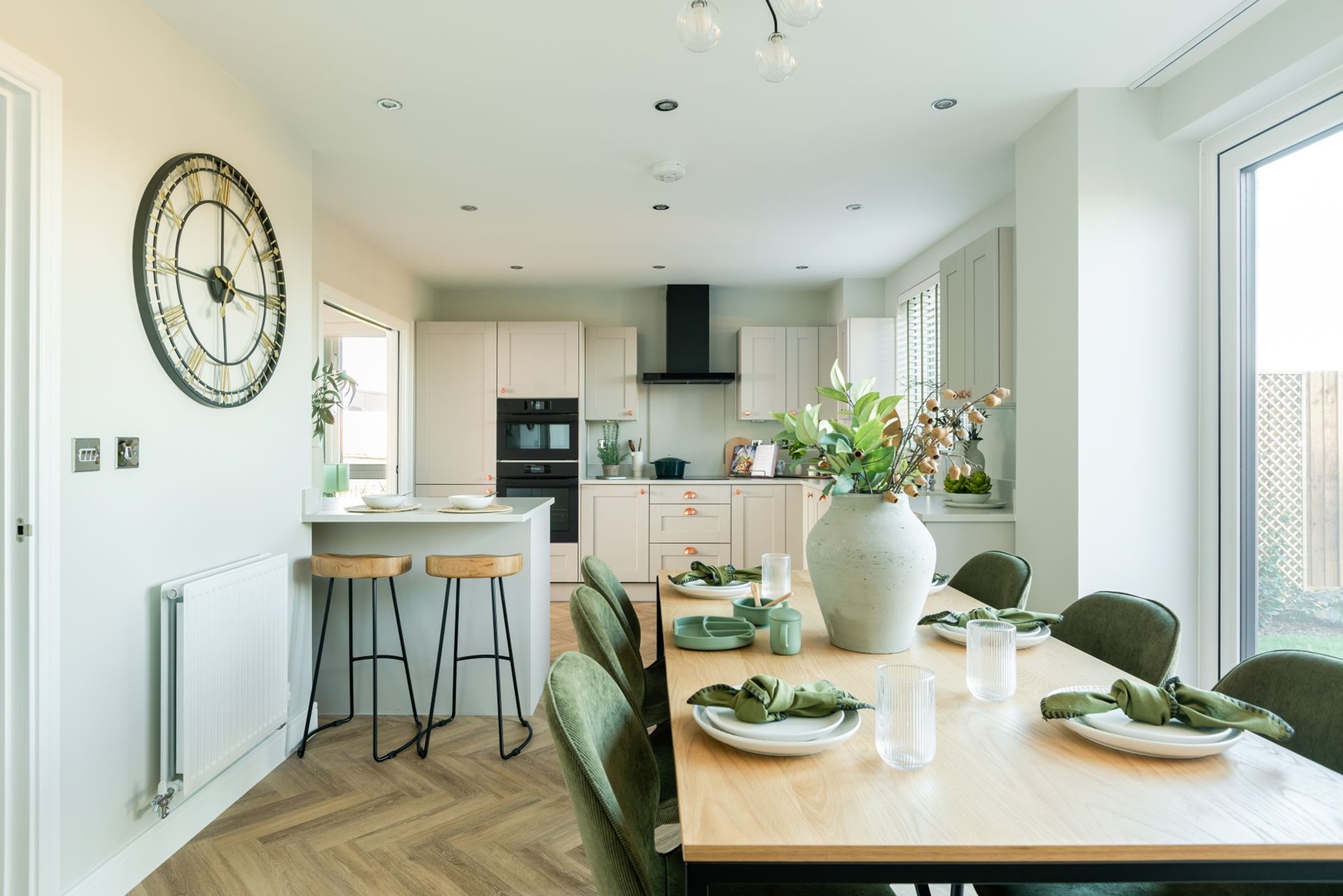 A modern kitchen, dining area with French doors into the rear garden