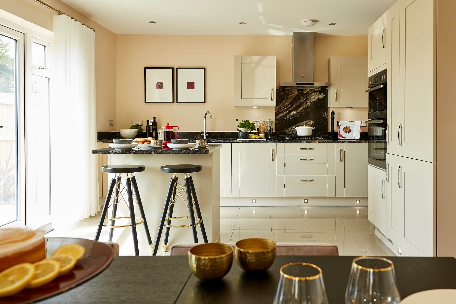 A modern kitchen/dining area with doors out to the garden