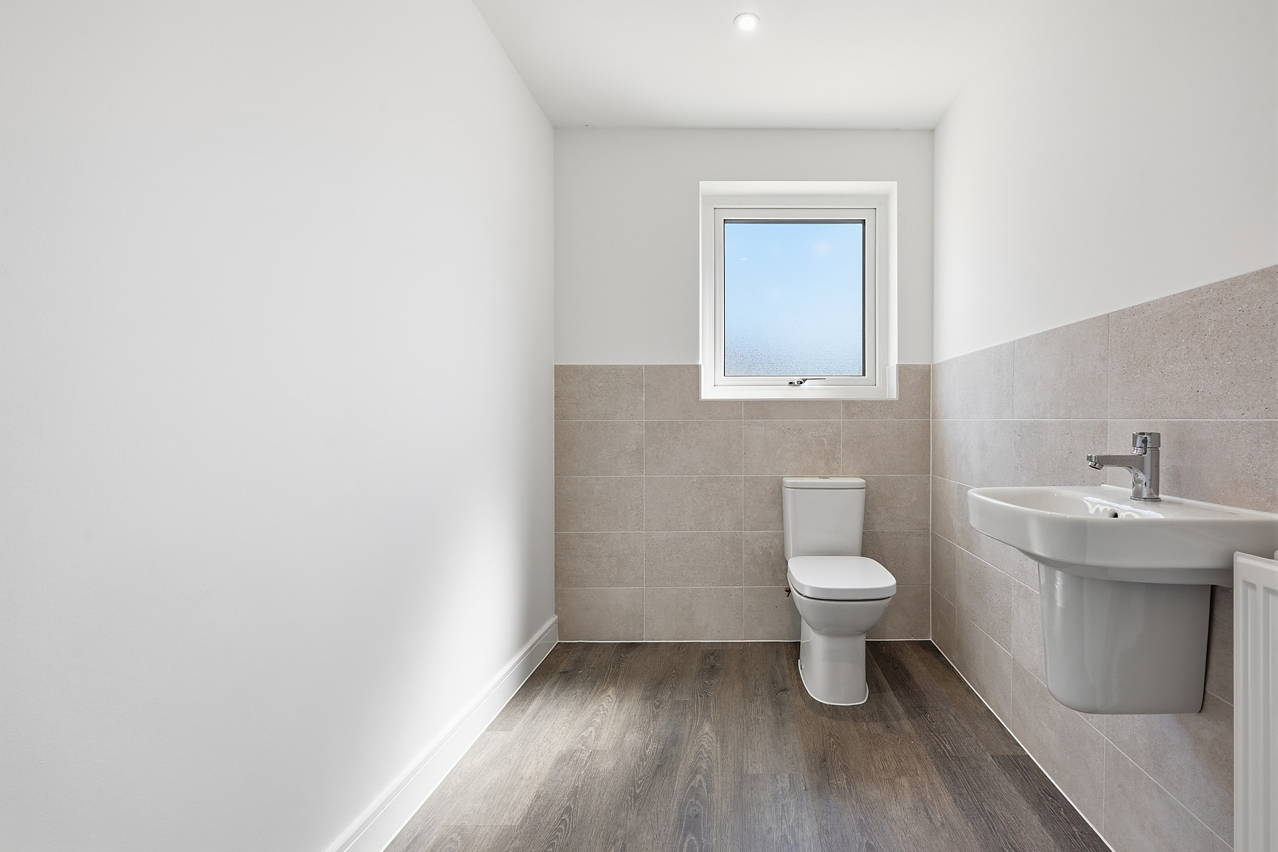 This handy downstairs cloakroom has space for your laundry baskets