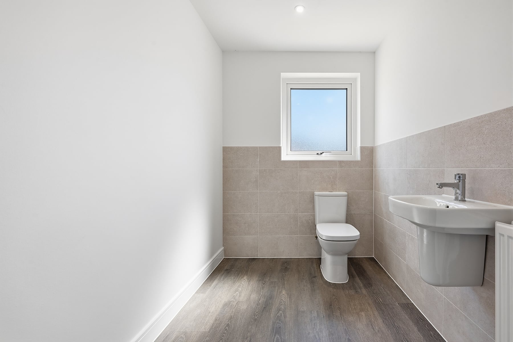 This handy downstairs cloakroom has space for your laundry baskets