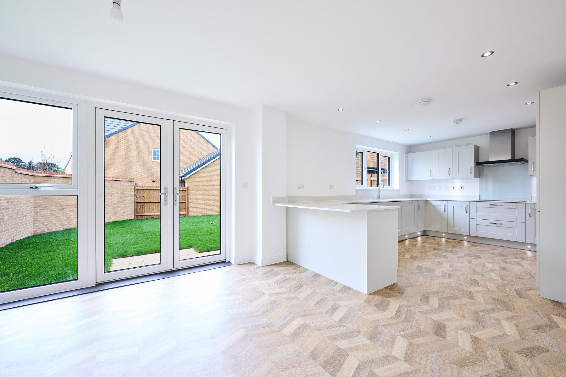 The timeless kitchen is a generous size with feature flooring