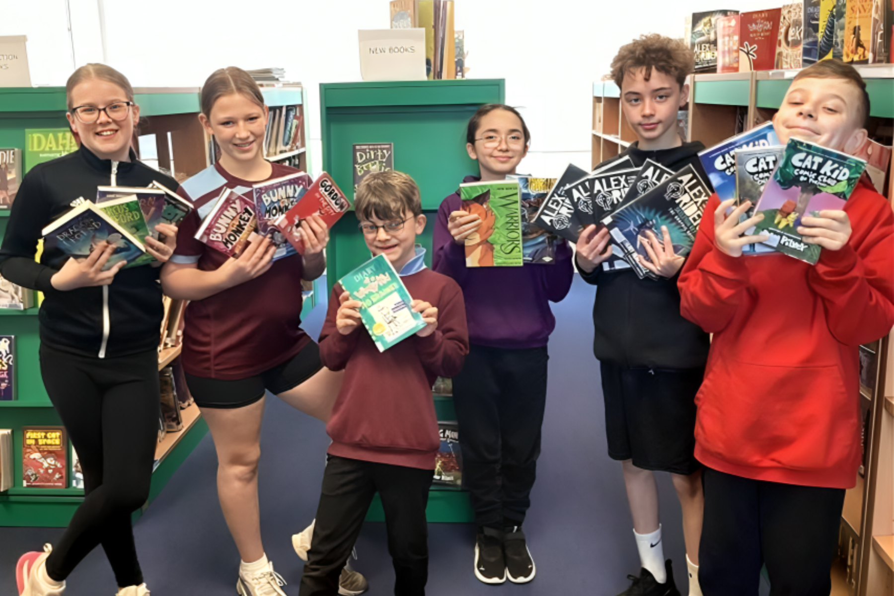 Bordon Junior School pupils with the books that Taylor Wimpey's donation funded