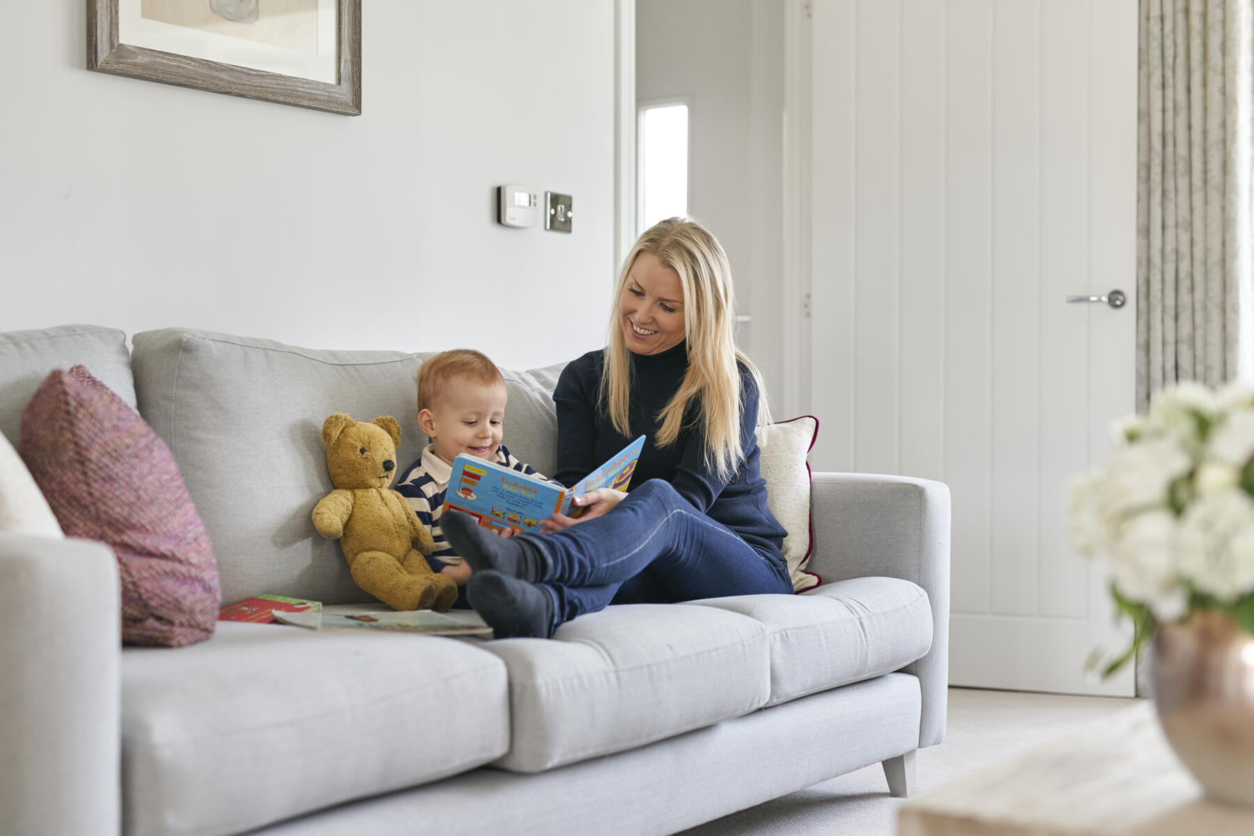 Mother with child on sofa reading