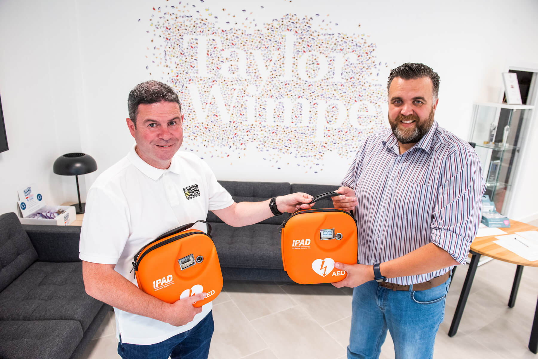 two lifesaving defibrillators to the Kieran McDade Foundation North Lanarkshire Taylor Wimpey