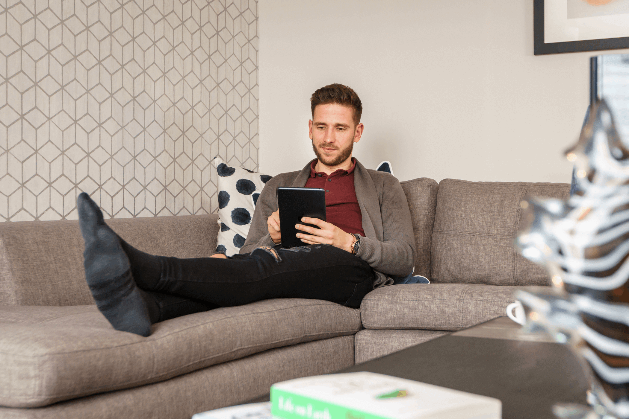 Man sitting in living room on tablet