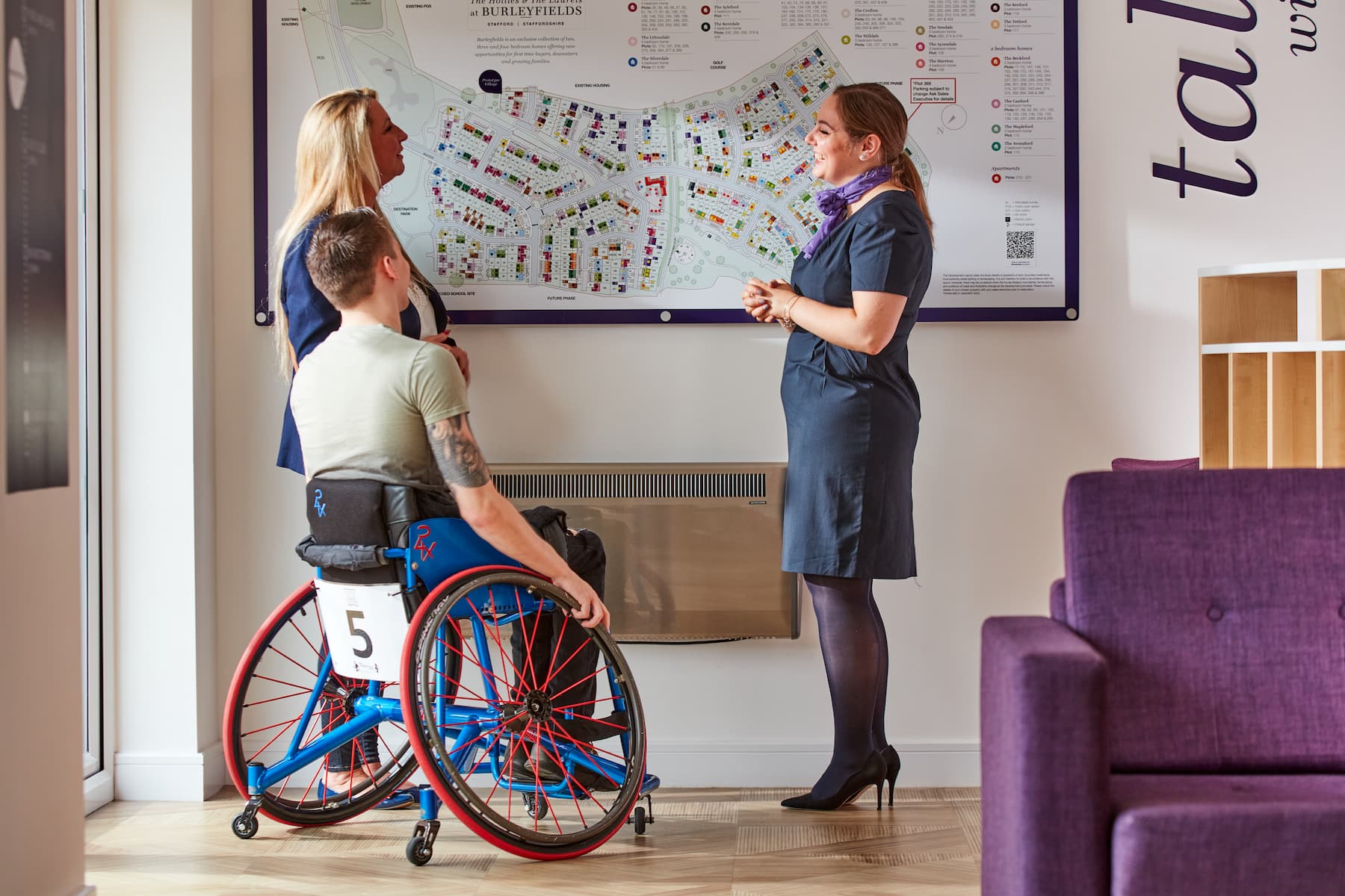 Taylor Wimpey staff member with customers