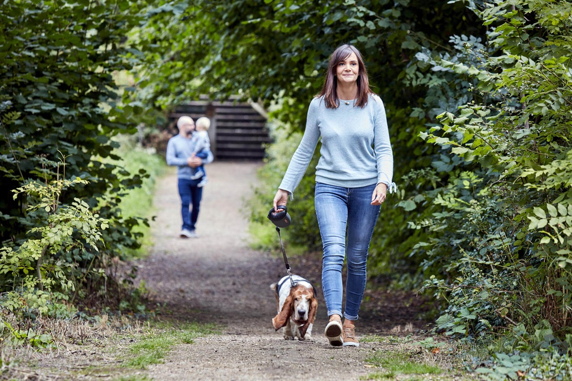 Customers walking dog in nearby park