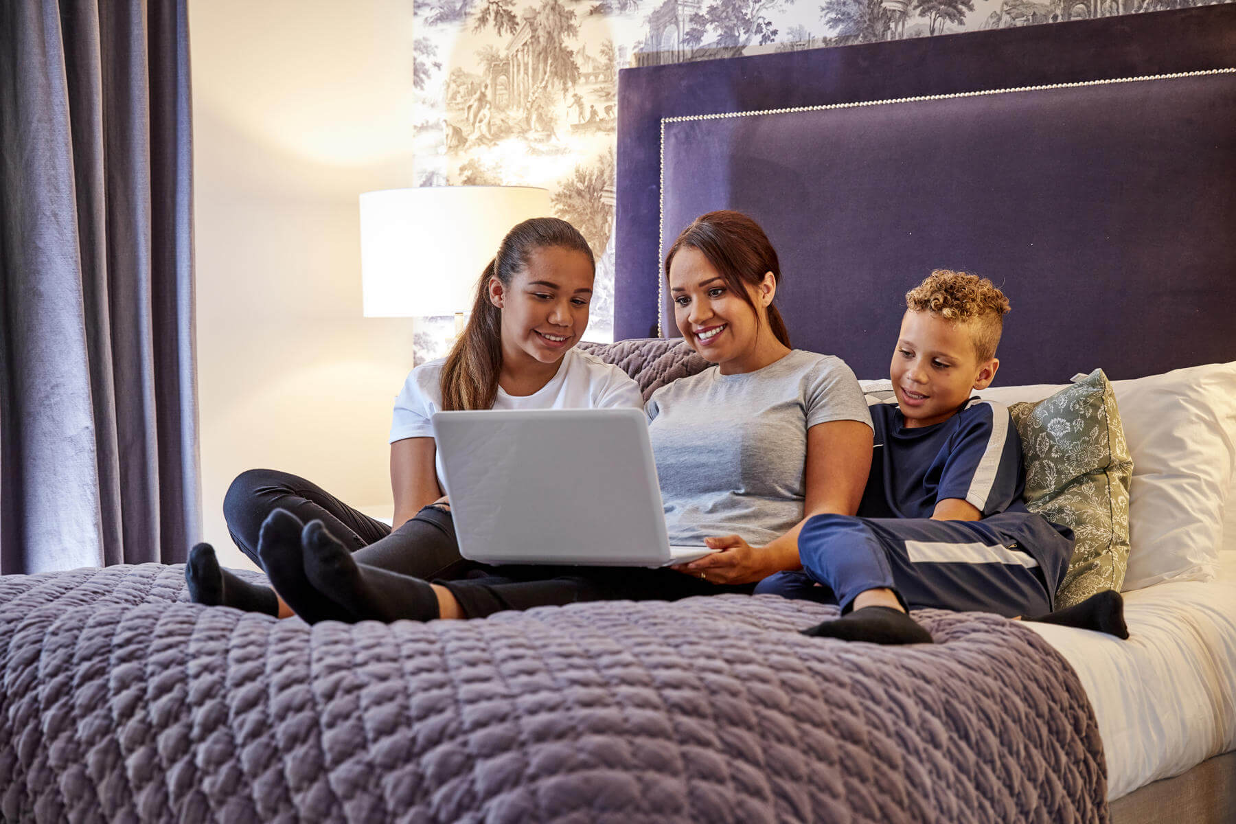 Family using a laptop in their bedroom