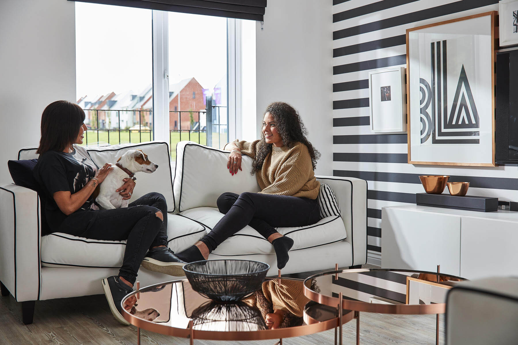 Friends and their dog in a living room
