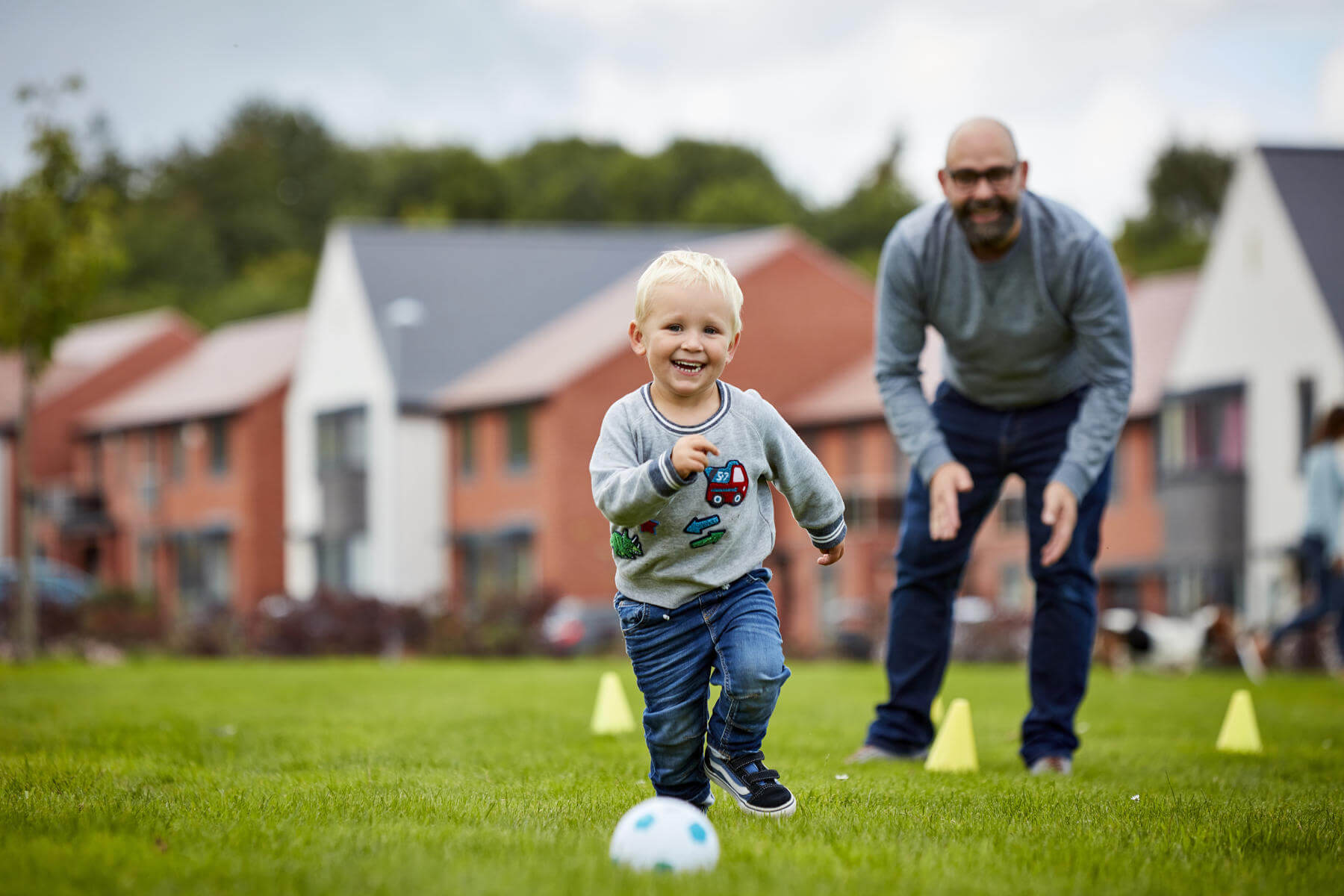 Family playing football near their new home