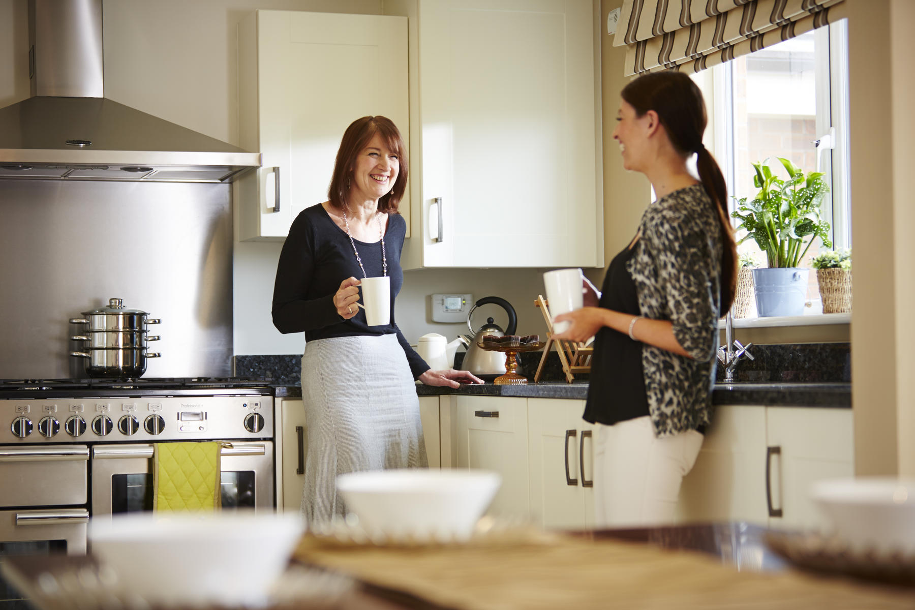 Friends drinking coffee in their new kitchen