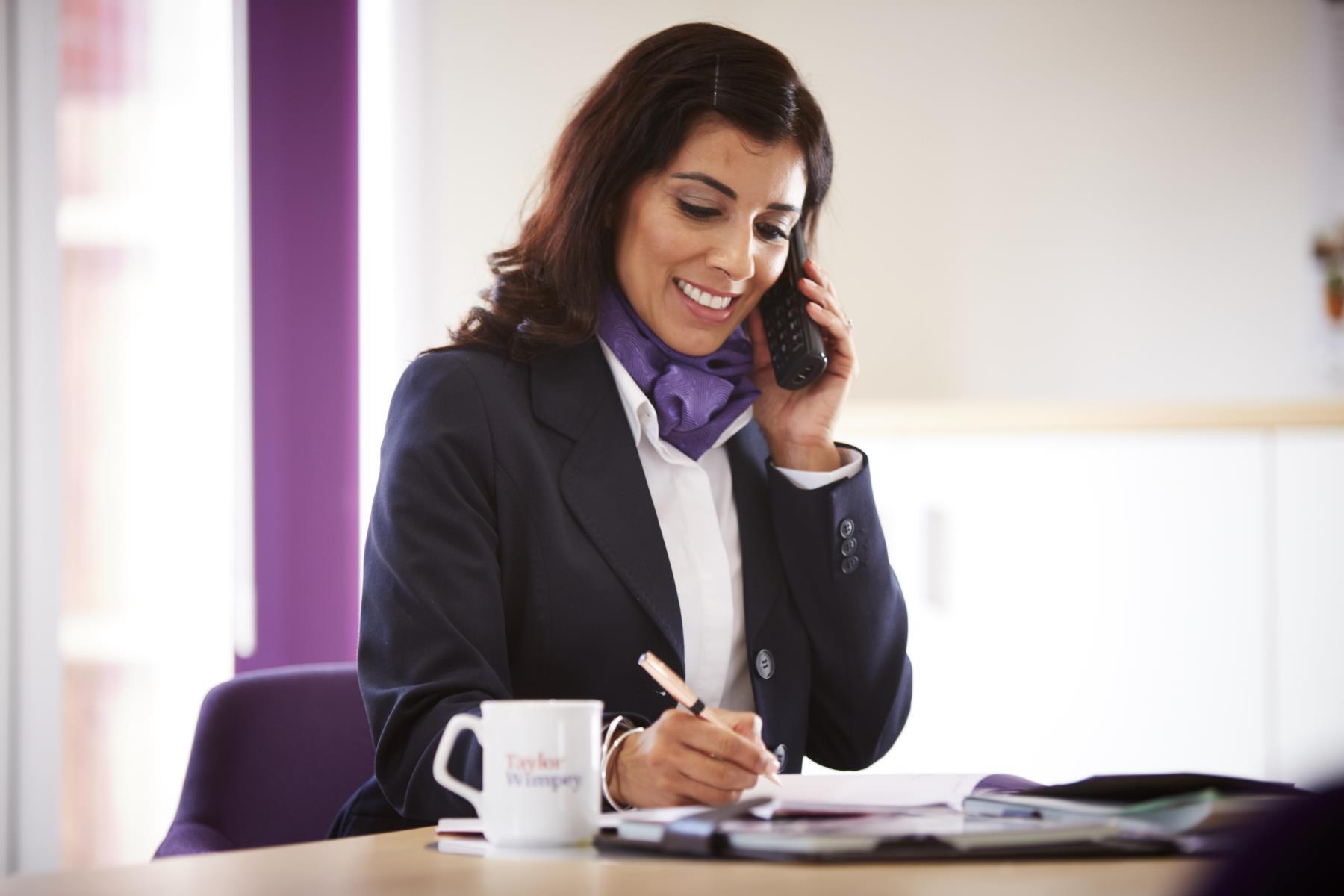 Taylor Wimpey Sales Executive on the phone