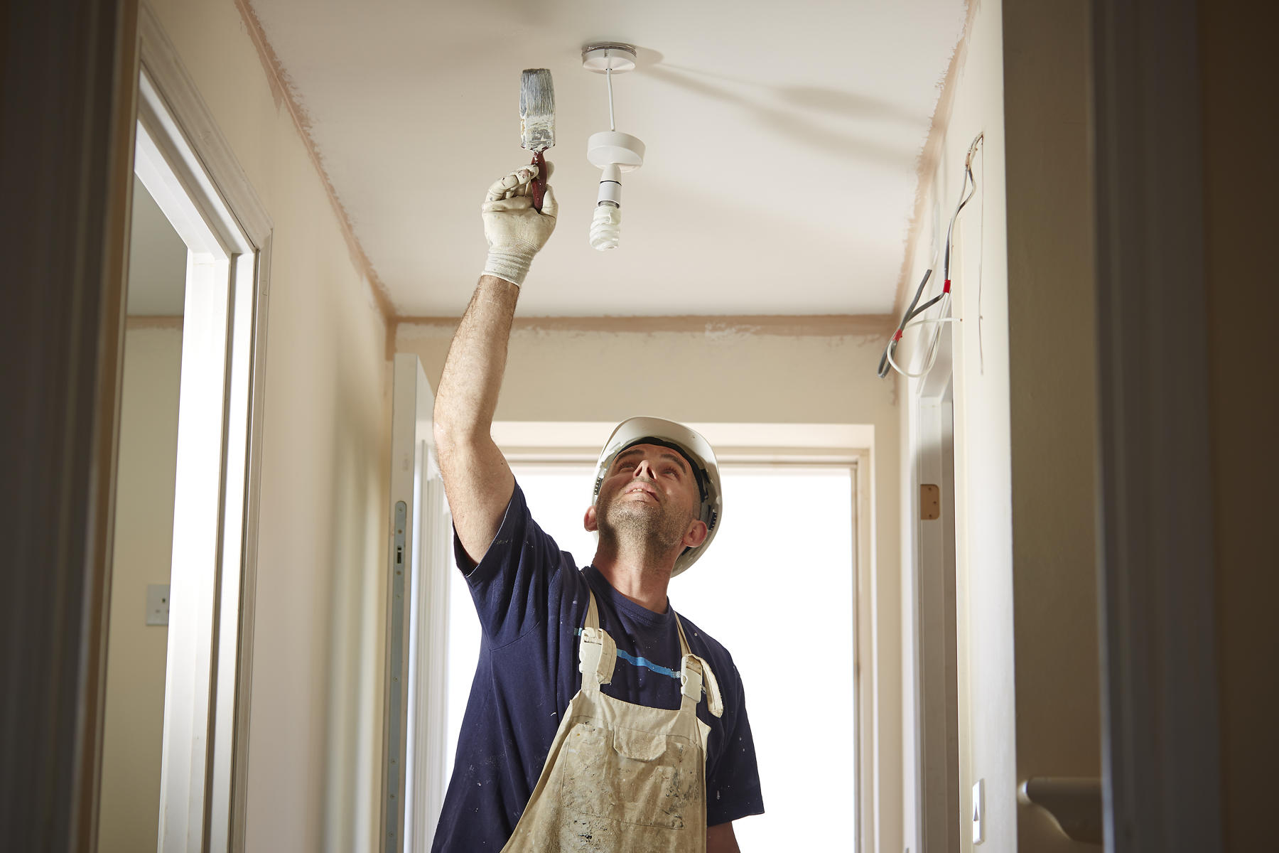 Man painting ceiling