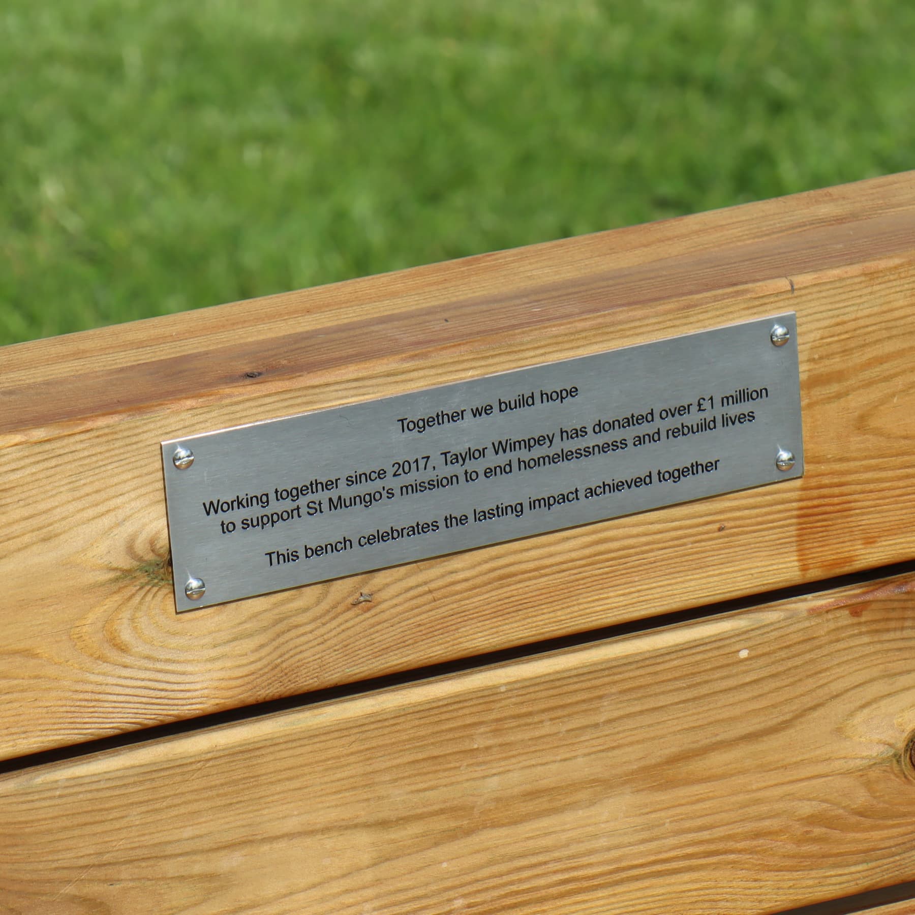 Taylor Wimpey plaque on bench