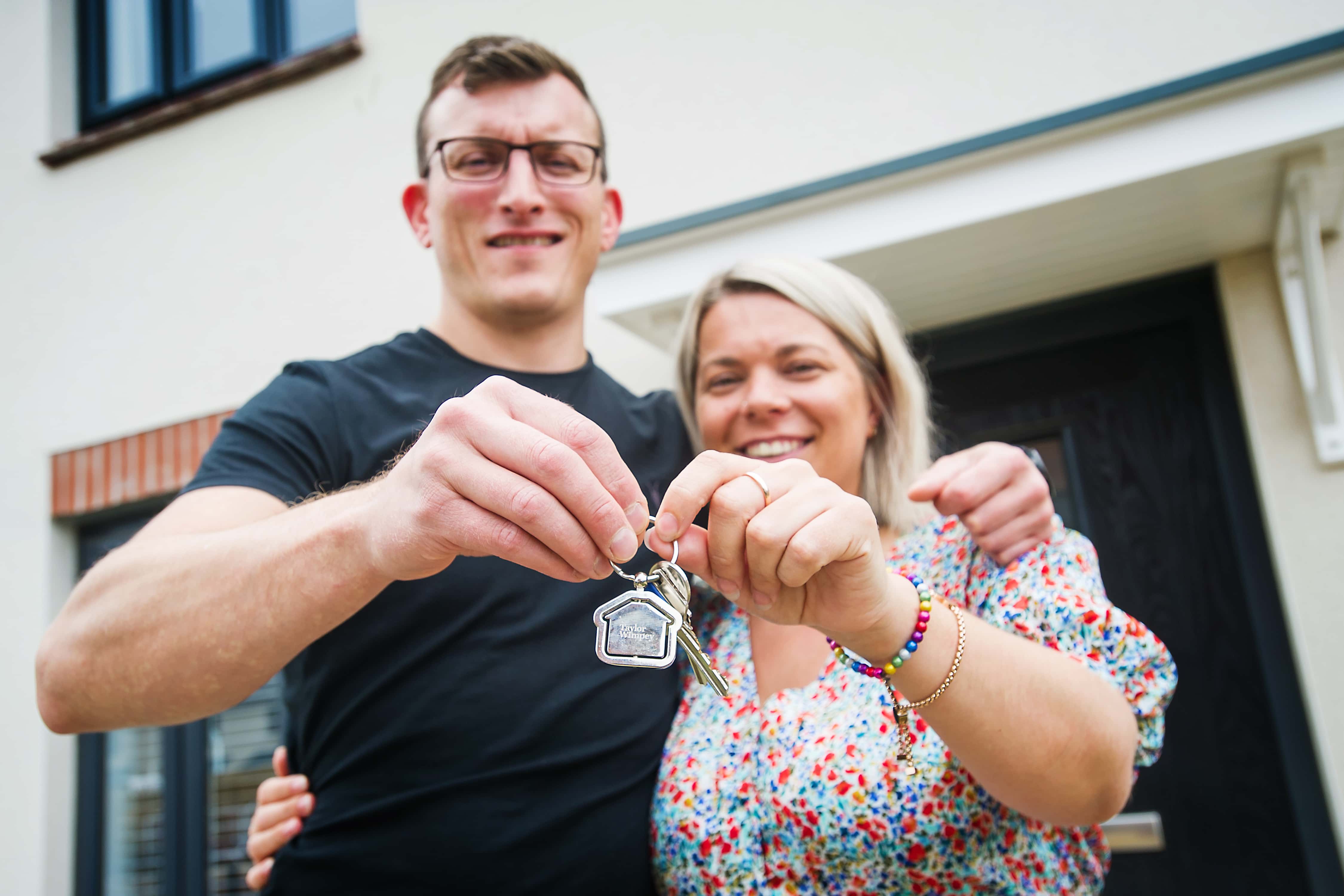 A couple holding keys to their new home