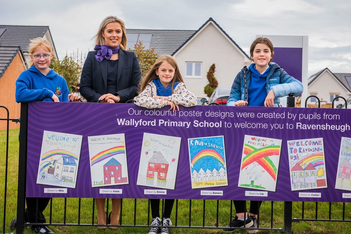 Group of children and Taylor Wimpey sales executive at development in Wallyford.
