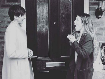 Two people outside front door
