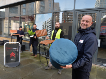 Men outside holding furniture