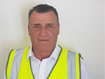 Head shot of man in high vis jacket and white shirt
