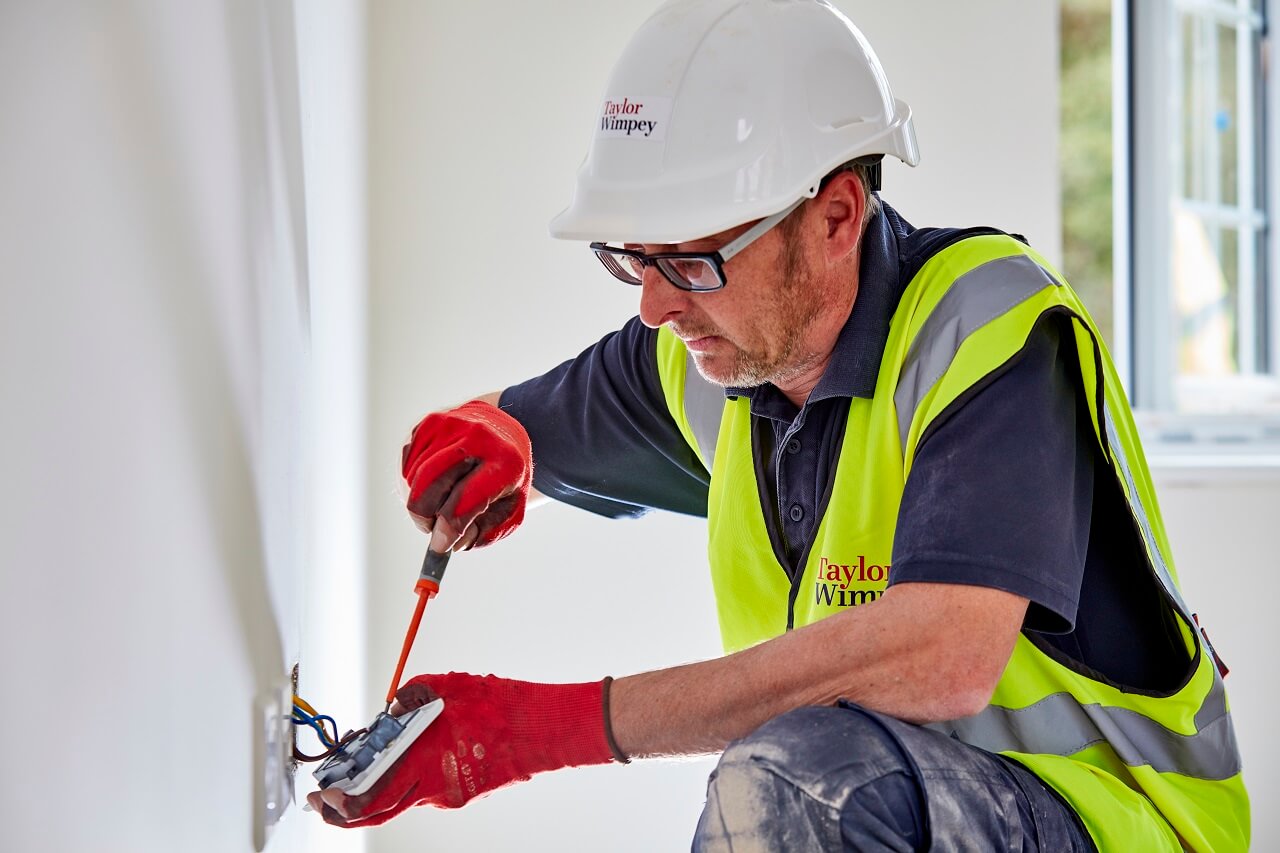 Electrician fitting a plug sockets