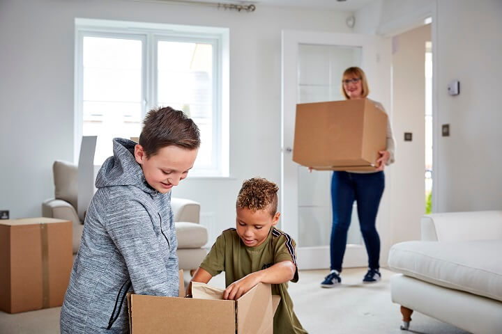 Woman and children moving in with boxes