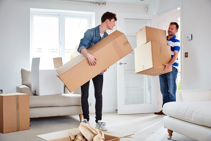 Men carrying boxes into new home