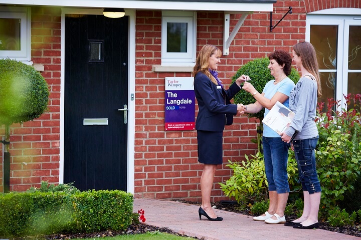 Family recieving keys to new home