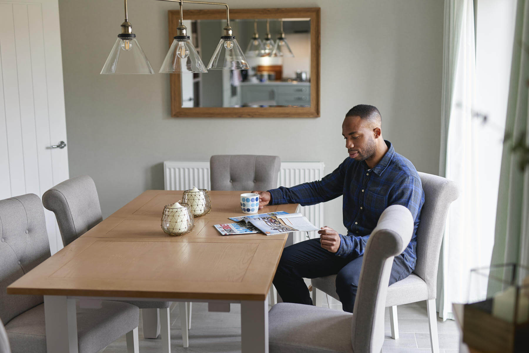 Man at table looking at phone