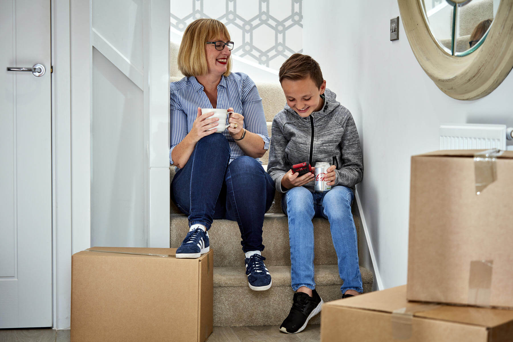 Mum and son sat on stairs