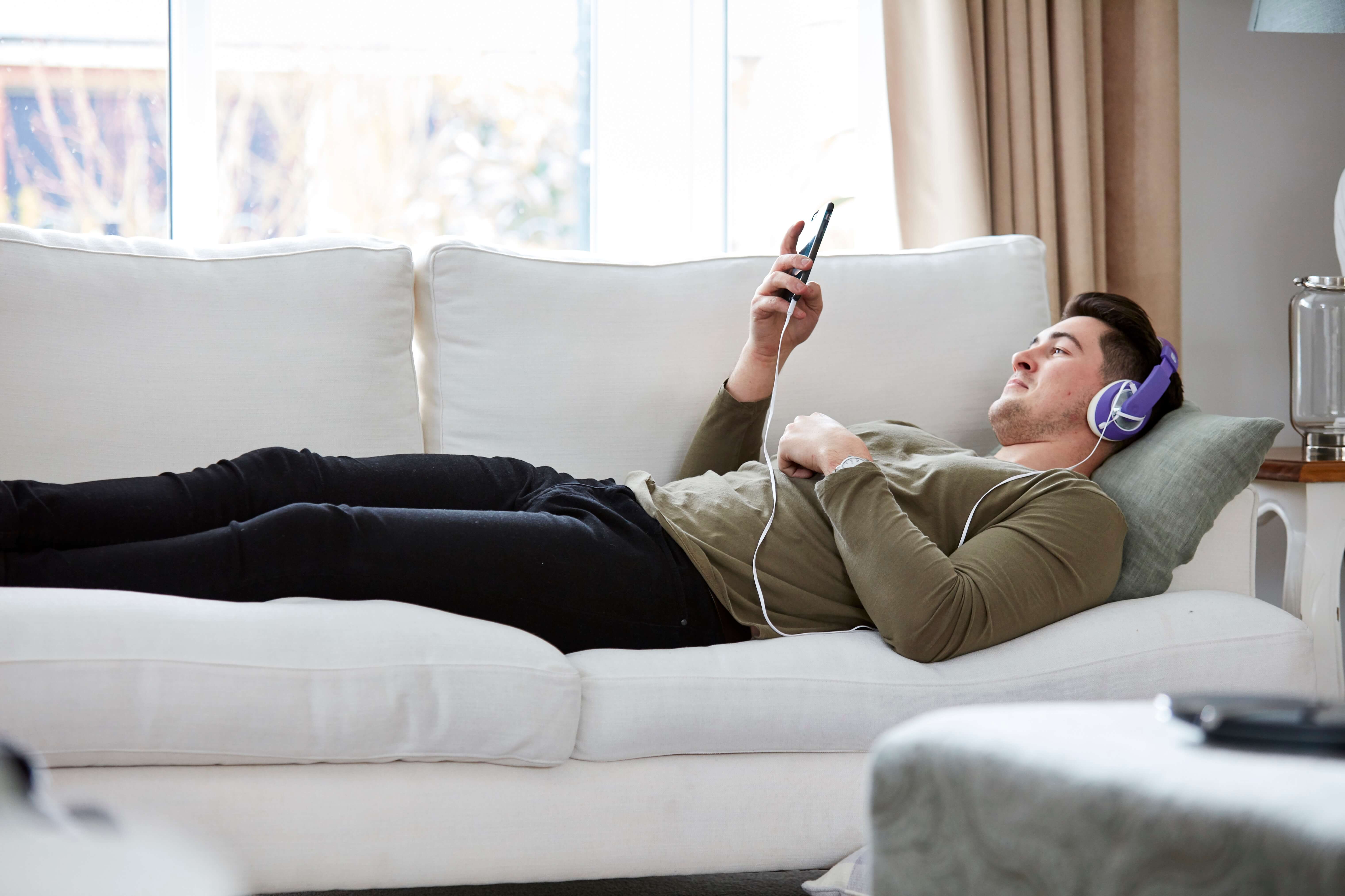 Man with headphones on mobile phone