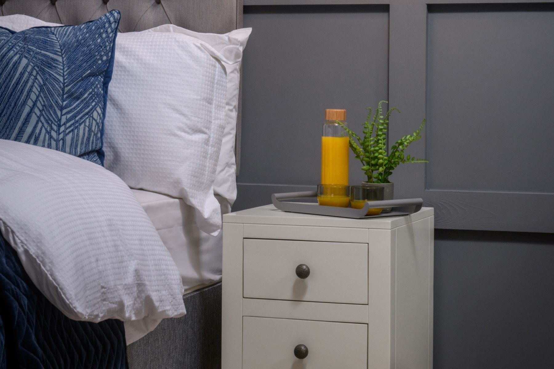 Bedside table with orange juice bottle close up