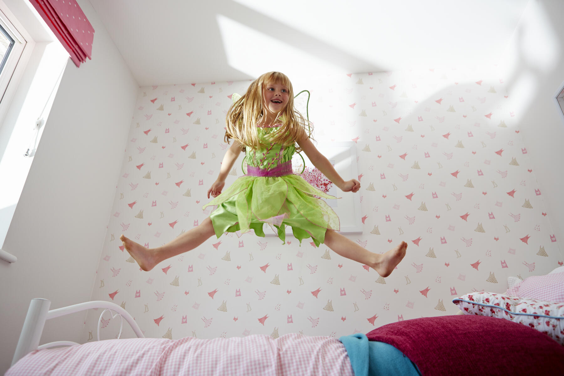 Girl jumping on bed