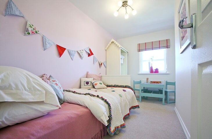 Pink child's bedroom with bunting