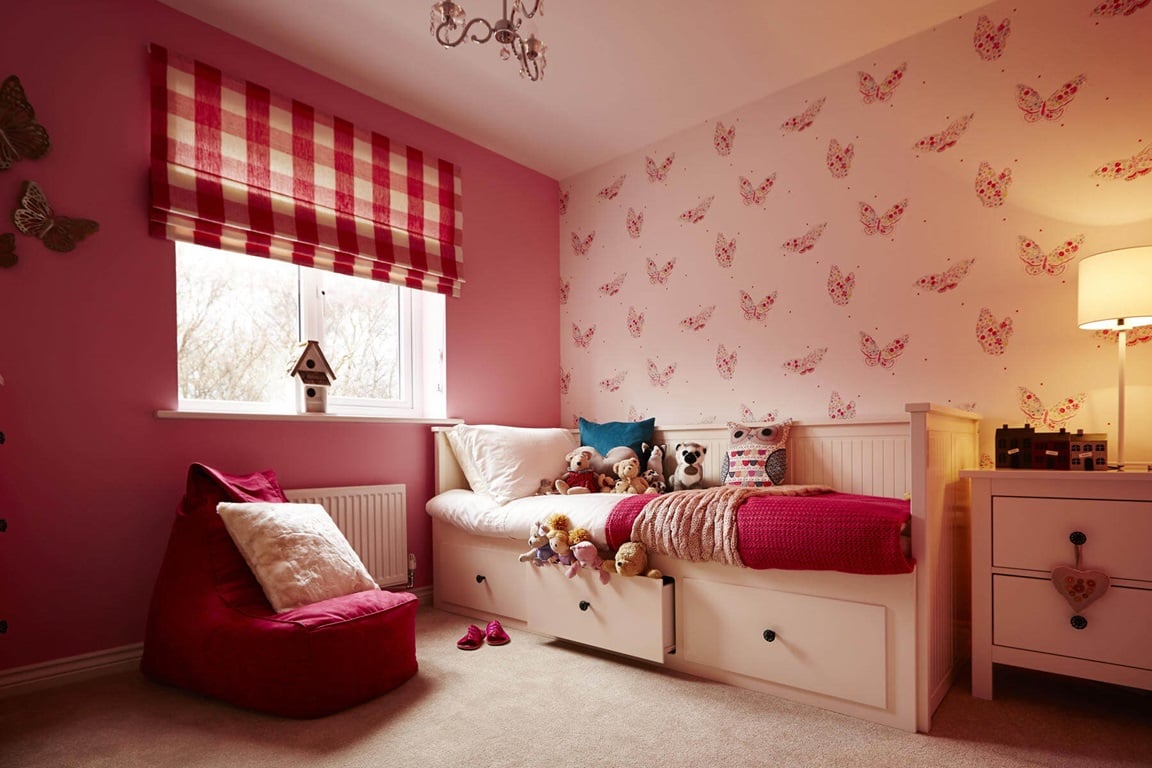 Child's bedroom in shades of pink and red, from The Enysham show home, Silver Waters