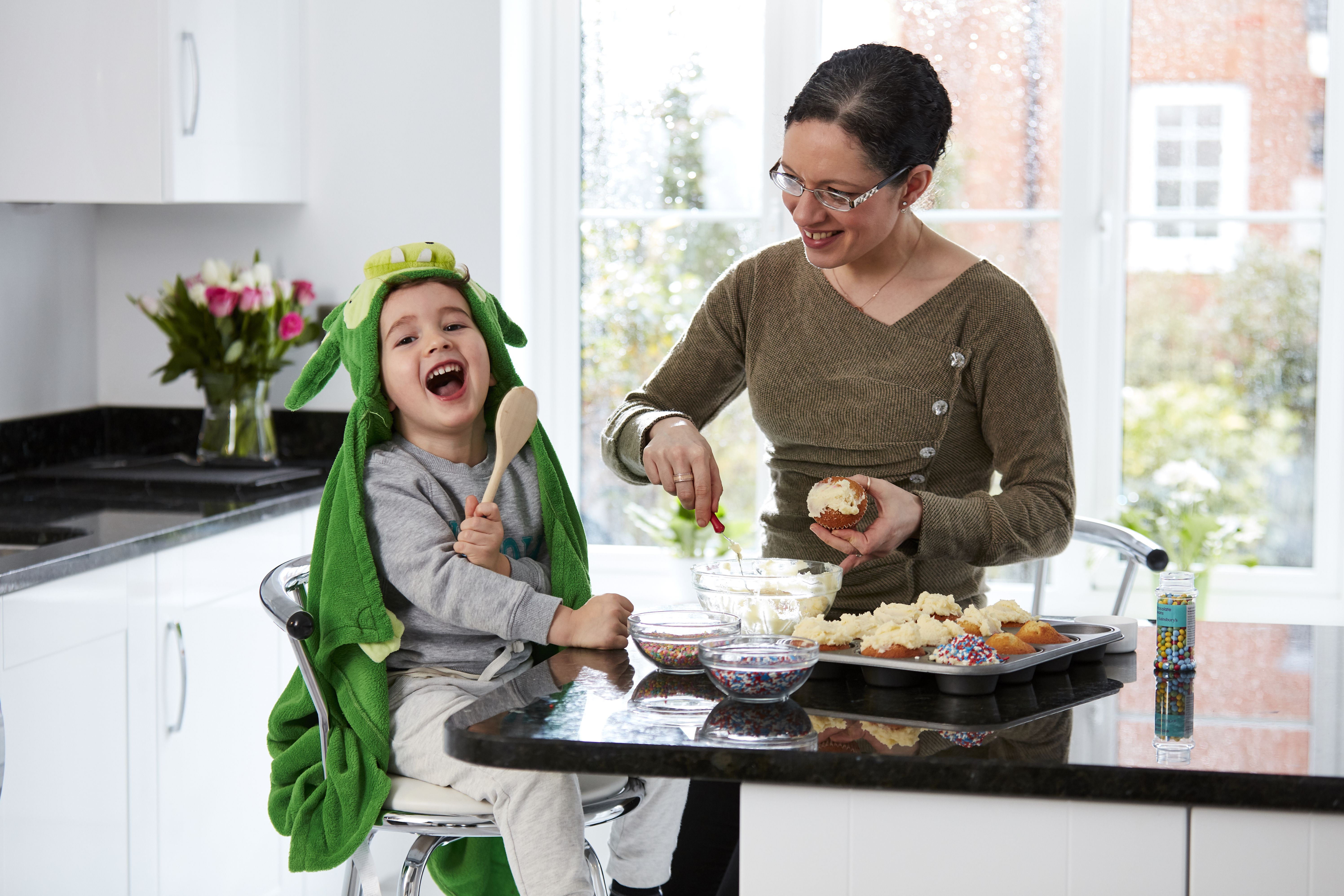 Mum and son baking in new Taylor Wimpey kitchen