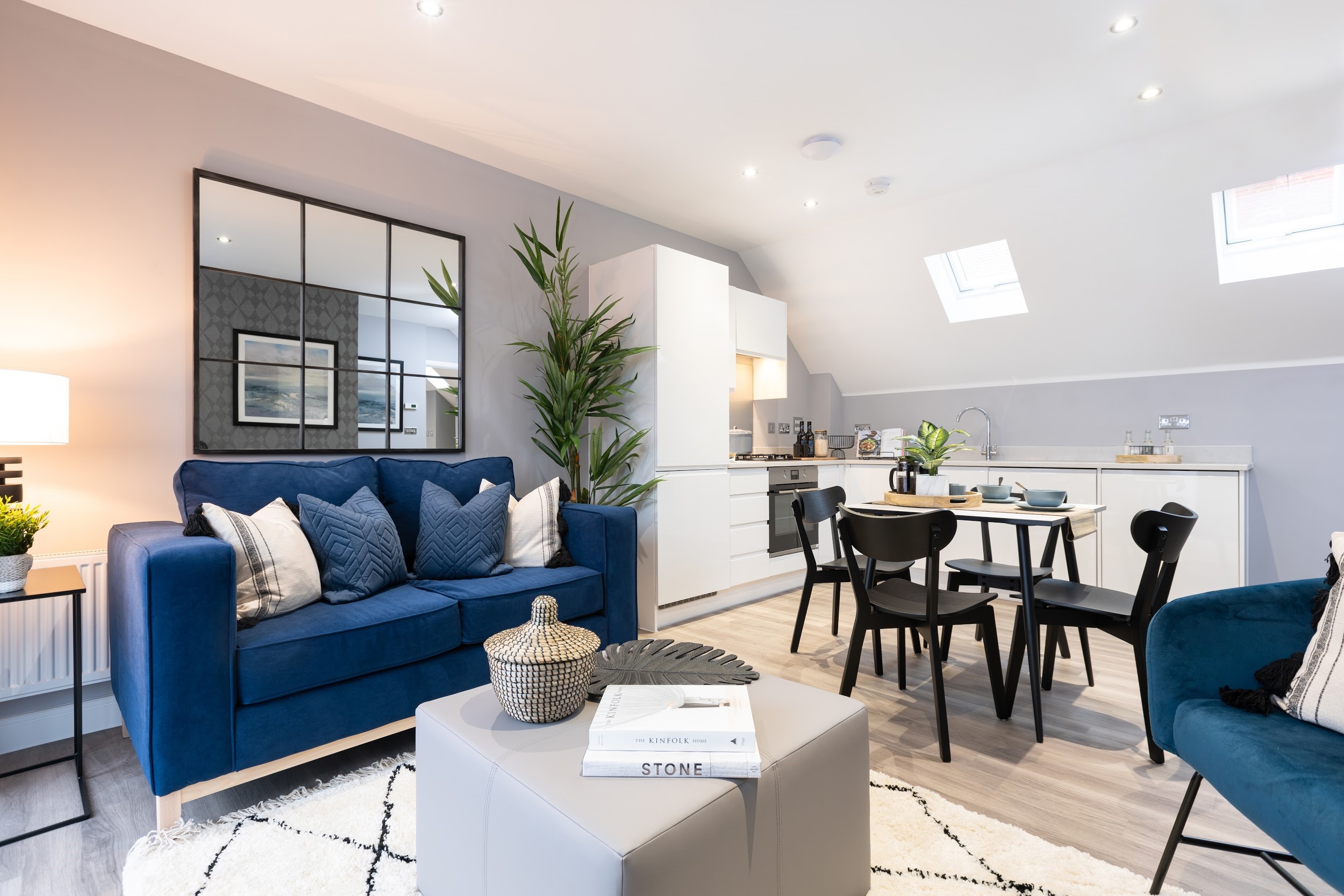 Kitchen diner with large mirror and blue sofa