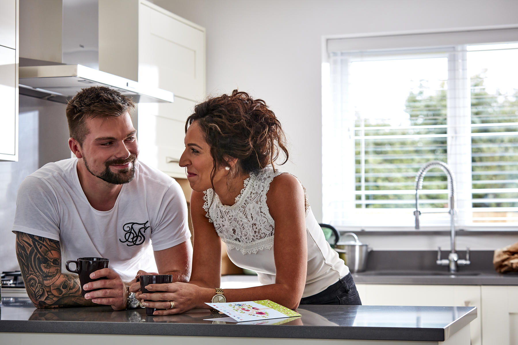 Couple smiling in kitchen